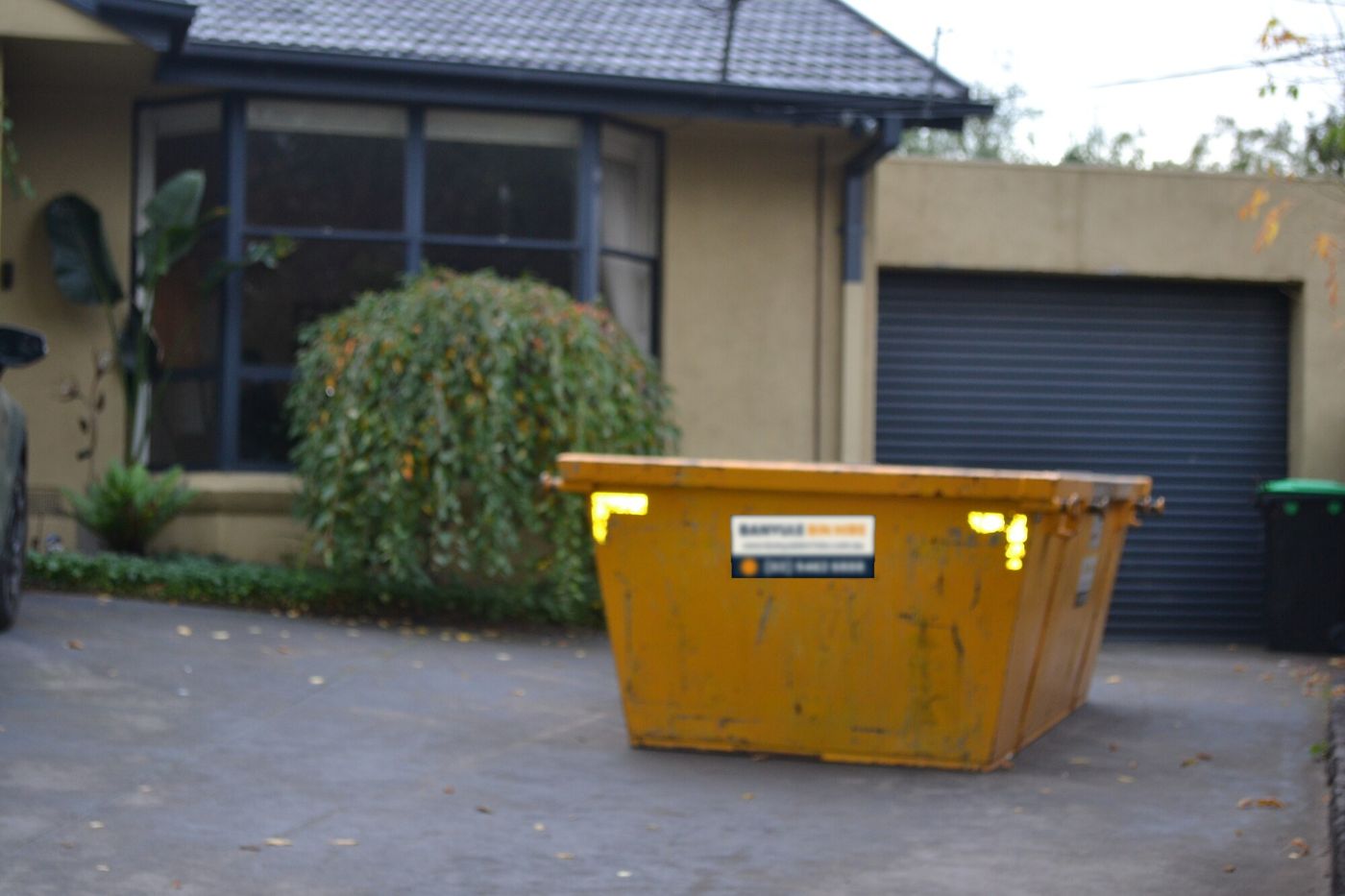Skip bin placed on a front driveway in Macleod